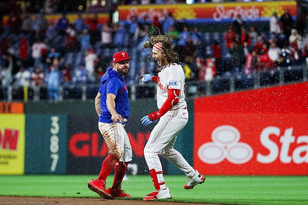 Alec Bohm of the Philadelphia Phillies celebrates with Kyle Schwarber of the Philadelphia Phillies after hitting a sacrifice fly to defeat the San...