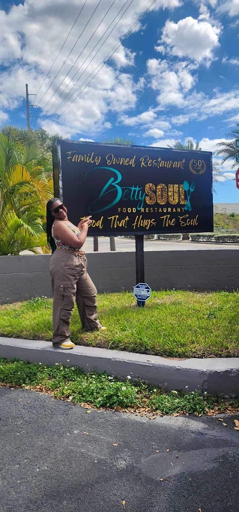 Left to right: Black woman throws up the peace side behind a forrest green plant back drop wearing a red distressed t-shirt that read "Birthday Cousin Cruise Crew". Black woman points toward black and blue sign that reads "Betty's Soul" a restaurant in Miami, Florida. Black Woman poses in front of turquoise ocean in a multicolor matching shirt and short set