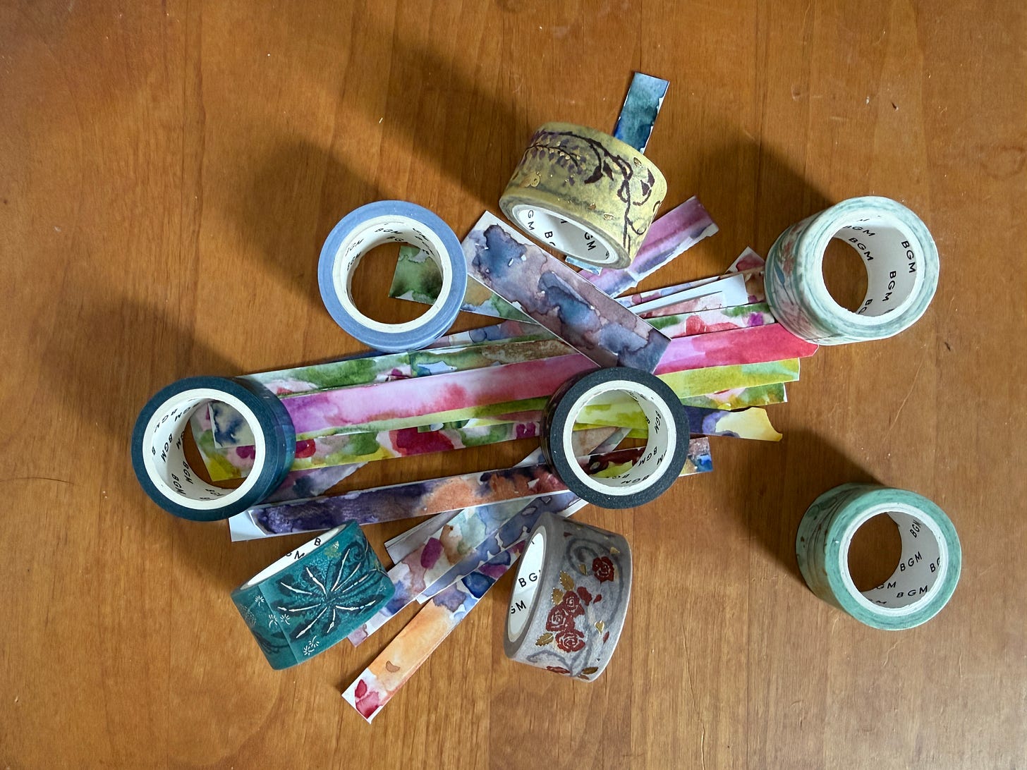 Collection of washi tape rolls including hand-painted varieties in multiple colors and patterns. Collection of washi tape rolls including hand-painted varieties in multiple colors and patterns.