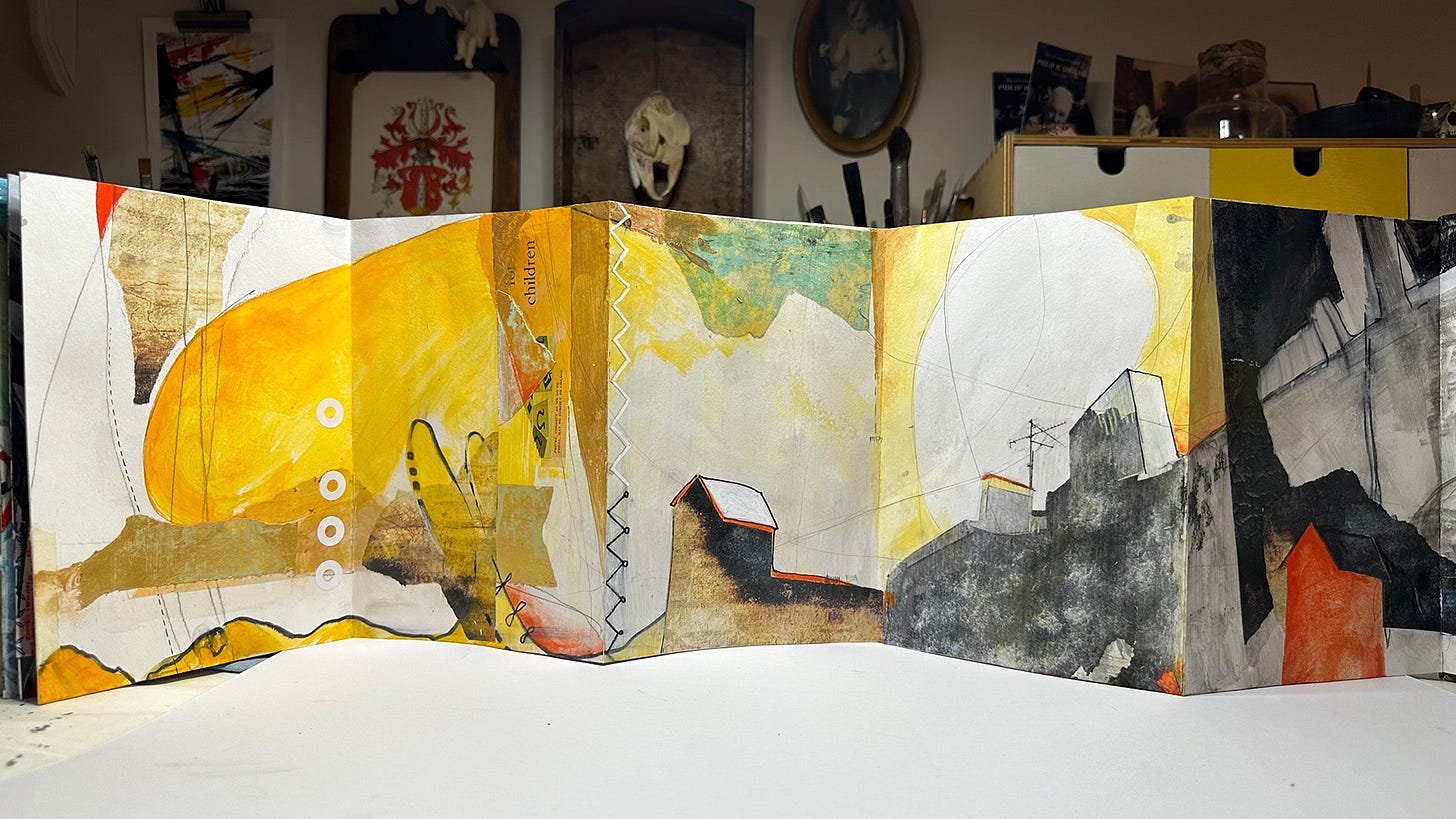 several pages from a concertinal sketchbook spread out- abstracted mixed-media work in it