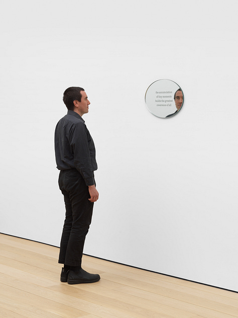 A series of three images of mirrored work with texts engraved on them. The third image features Al Svoboda for scale.