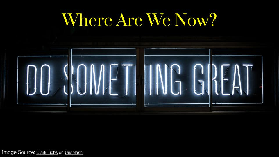 A neon sign with a black background that reads "Do something great" while the title of the slide reads, "Where Are We Now"
