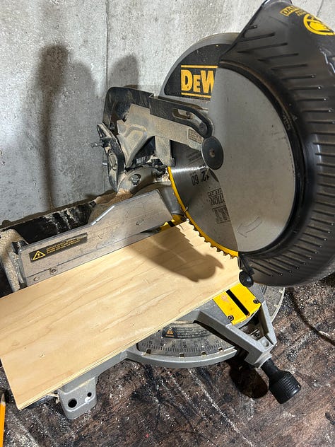 miter saw cutting a board for an easy diy storage shelf