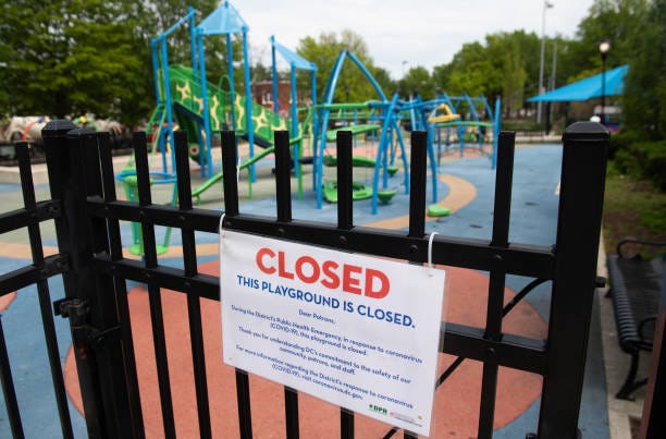 Signs hangs outside a closed playground in Washington, DC, April 29, 2020. - Washington will uphold coronavirus restrictions through May 15, 2020.