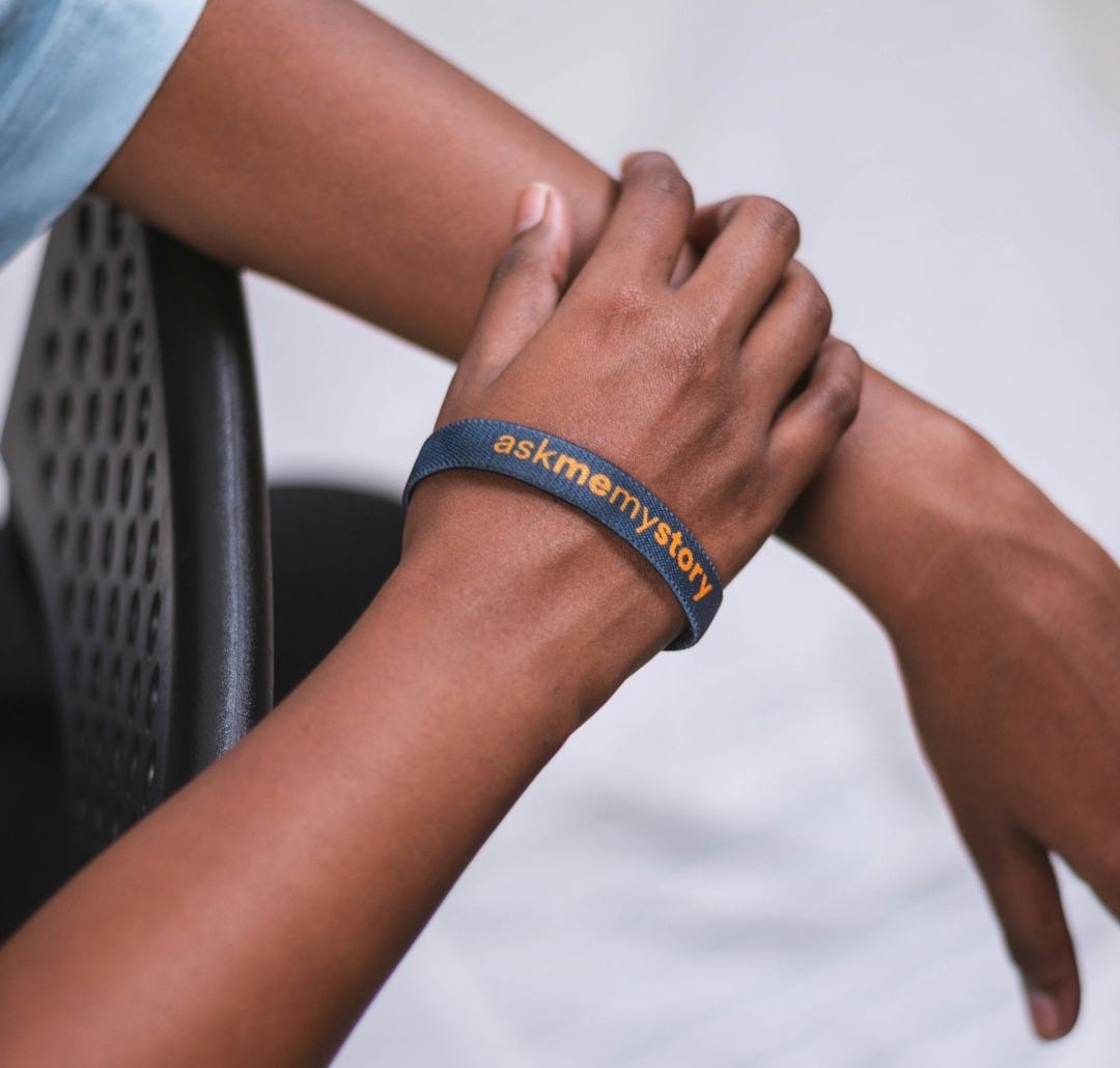 a person wearing a bracelet with a name on it