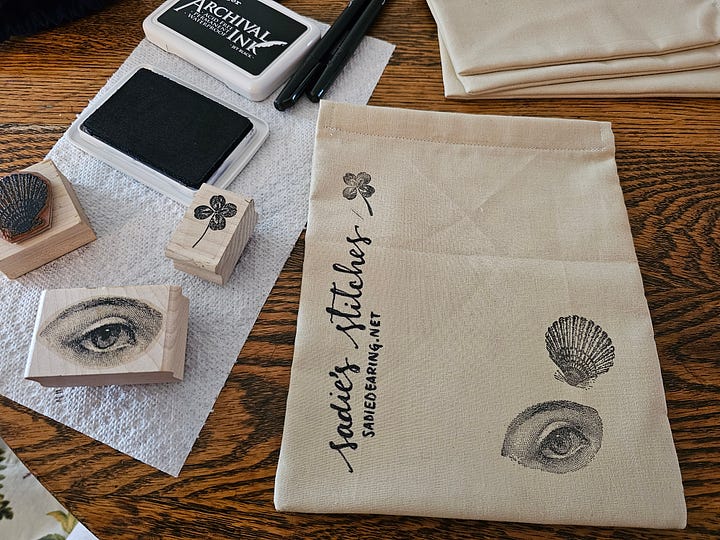 an array of drawstring bags and black ink stamps