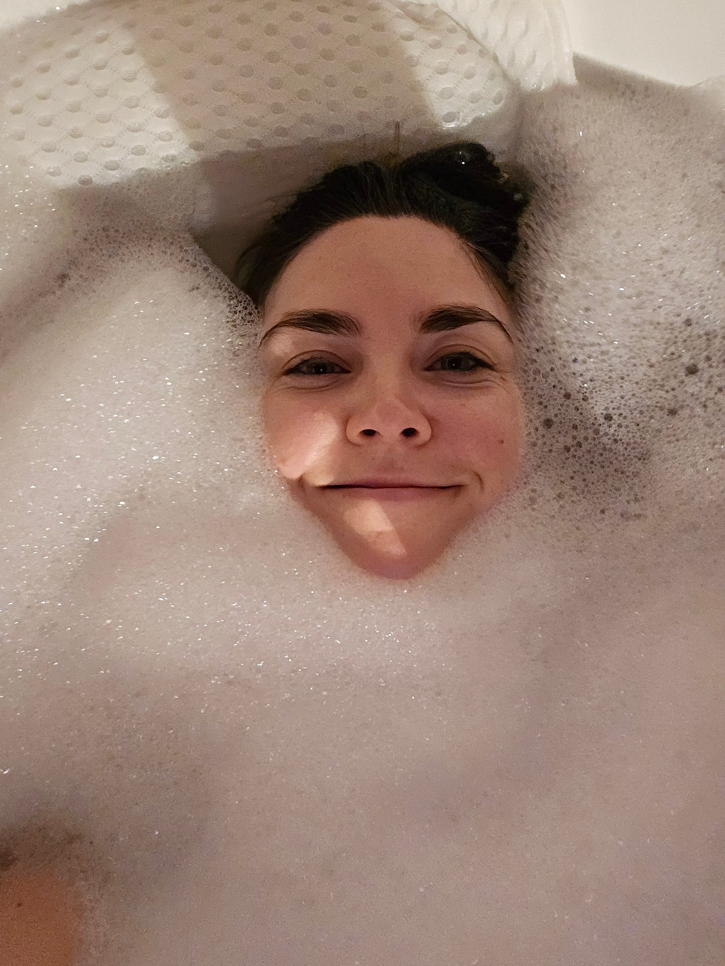 Cassidy's face surrounded by bubbles in a bubble bath Cassidy's face surrounded by bubbles in a bubble bath