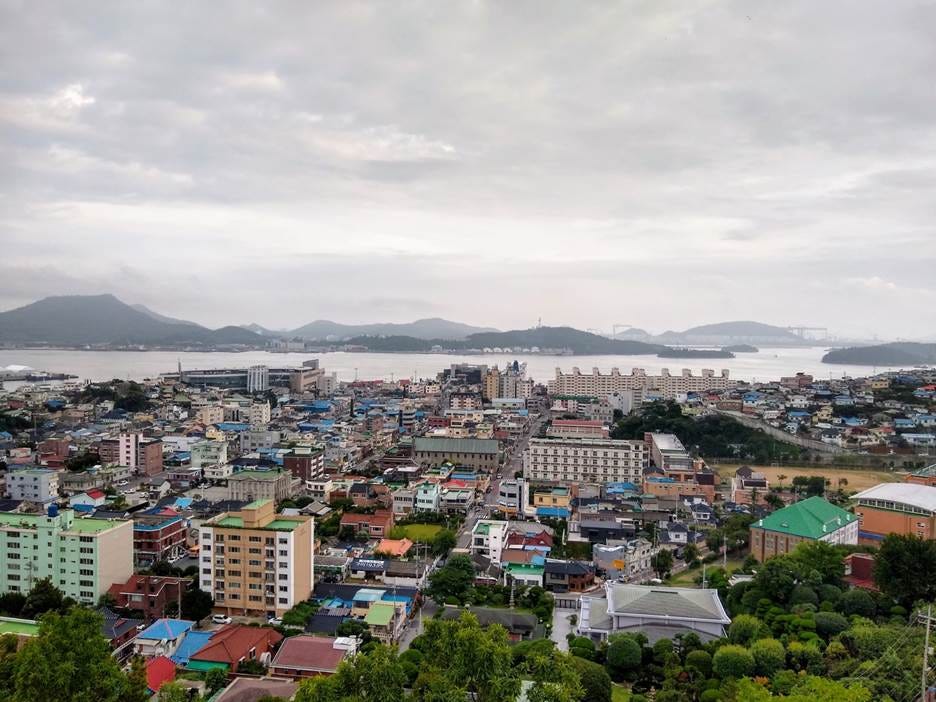 A city with buildings and water in the background

AI-generated content may be incorrect.