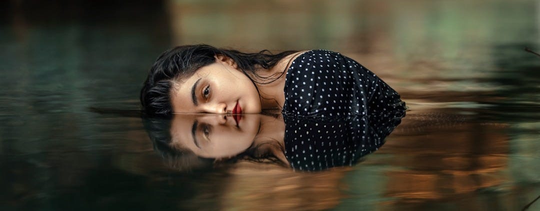 a woman is floating in a body of water