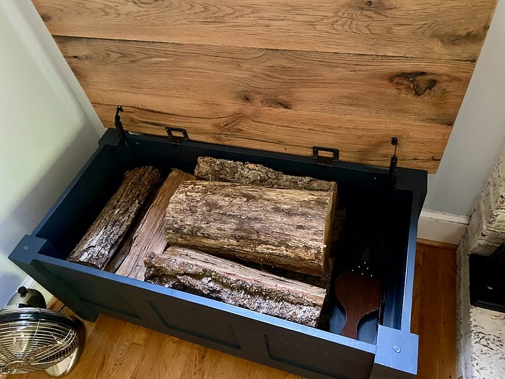 Screwing in a lid support and seeing the open storage bench.