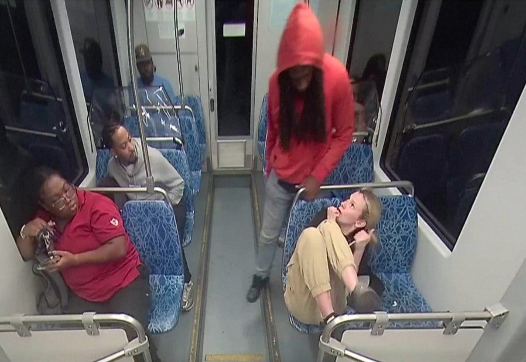 Surveillance video still image of a stabbing on a light rail train.