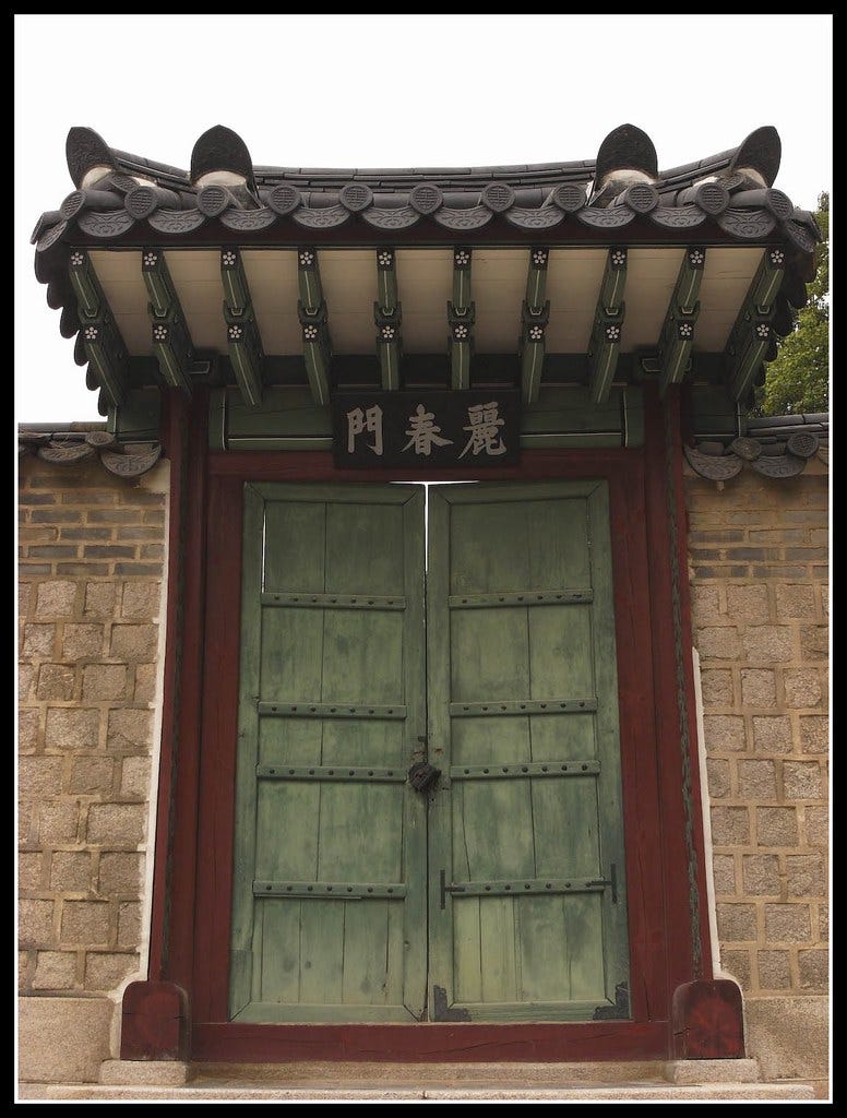 An Asian-style gate in a stone wall An Asian-style gate in a stone wall