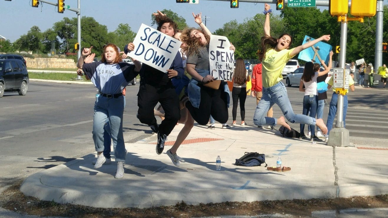 A group of people jumping in the air

Description automatically generated