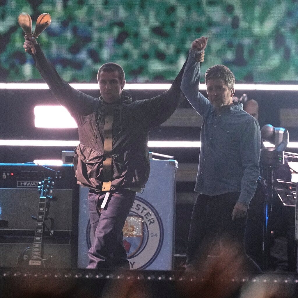 Two men onstage in casual clothing.