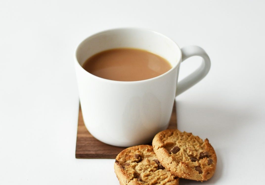 white ceramic coffee mug beside cookies white ceramic coffee mug beside cookies