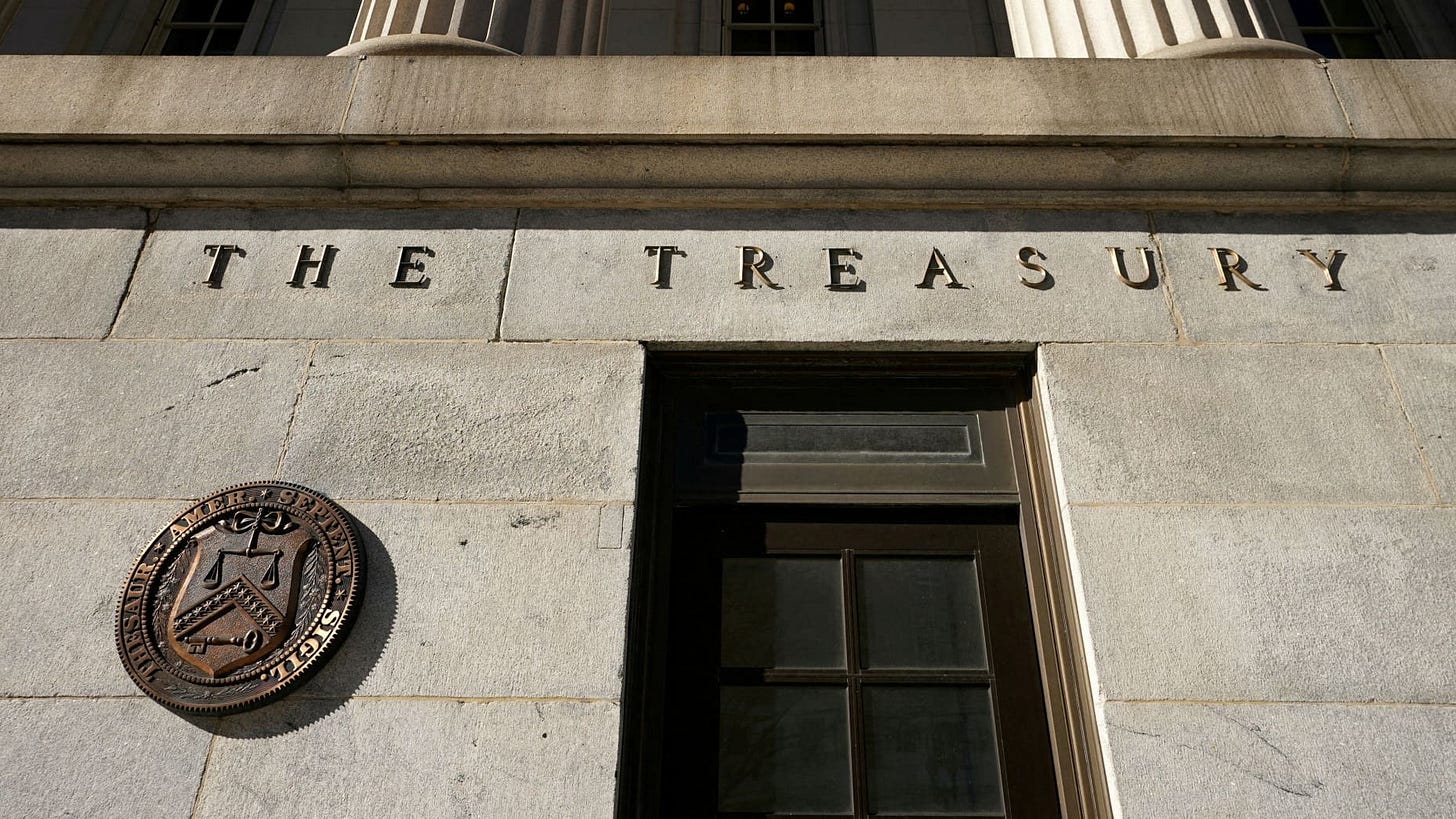 FILE PHOTO: A view shows a bronze seal beside a door at the U.S. Treasury building in Washington, U.S., January 20, 2023. REUTERS/Kevin Lamarque/File Photo