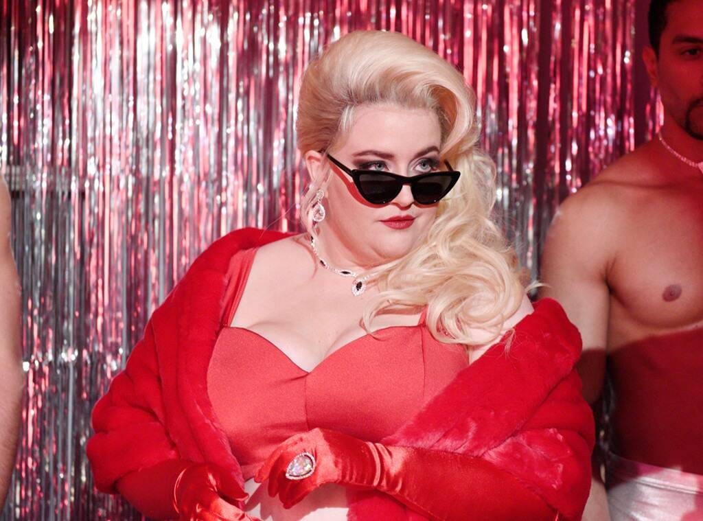Aidy Bryant looking super glamorous in a red robe