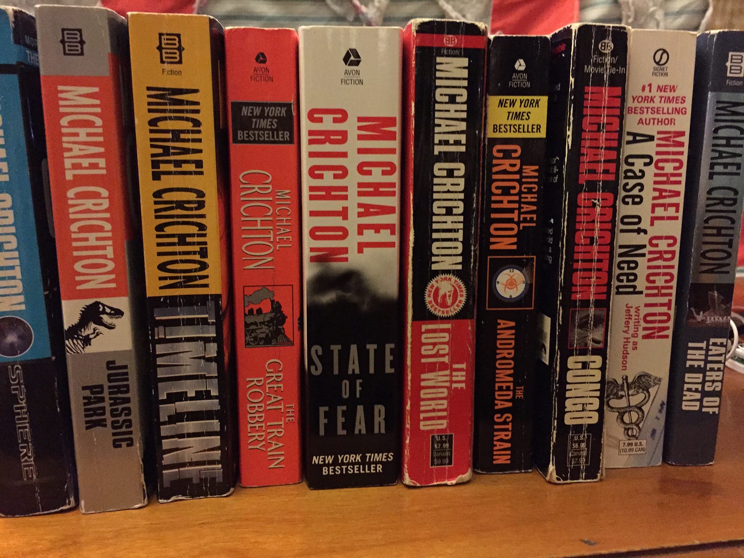 A row of books by Michael Crichton including Eaters of the Dead A row of books by Michael Crichton including Eaters of the Dead