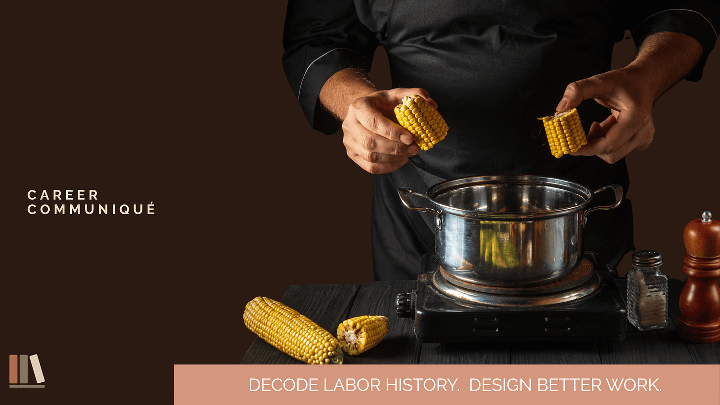 A chef in a black shirt snaps an ear of corn in half over a stainless steel pot, with whole and broken cobs resting on a dark wooden surface beside a salt cellar and pepper mill. The Career Communiqué wordmark appears at upper left, the GWHQ bookshelf monogram at lower left, and the tagline 'Decode Labor History. Design Better Work.' runs along a terracotta banner at the bottom.