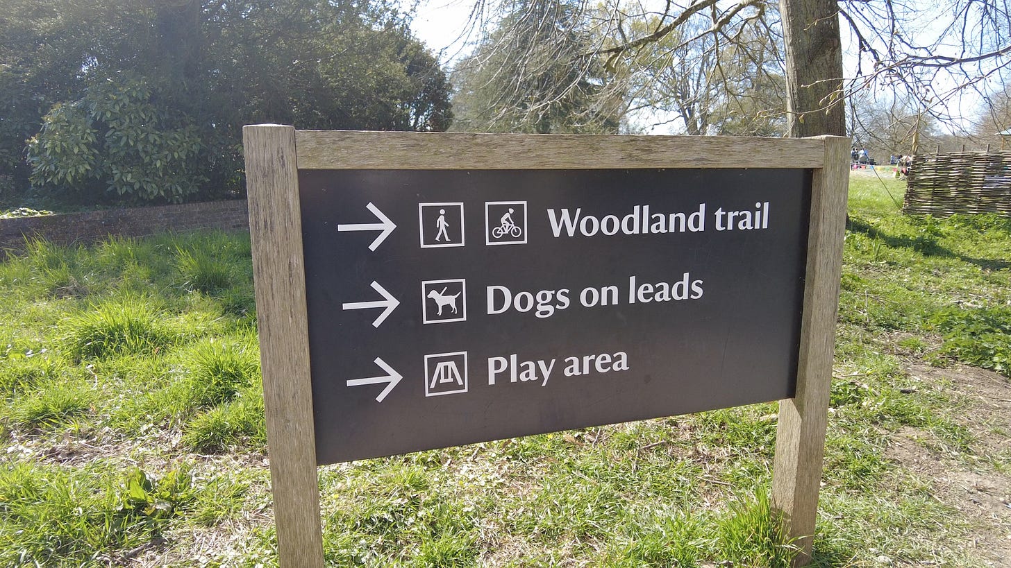 Sign pointing the way to the woodland trail at Kingston Lacy House