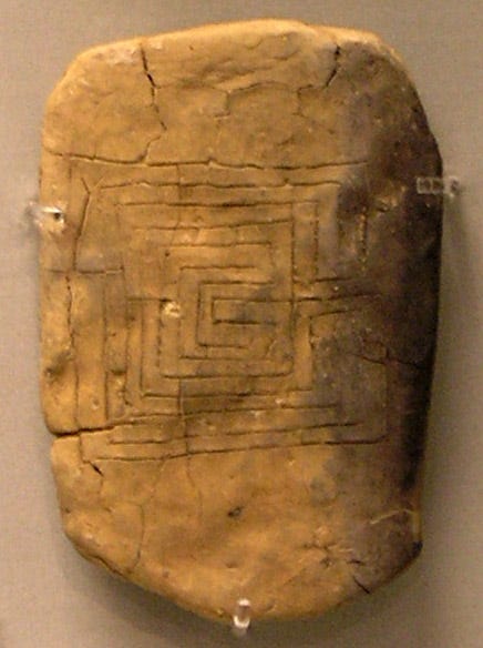 Roughly rectangular clay tablet with a squared-off labyrinth incised on the surface.