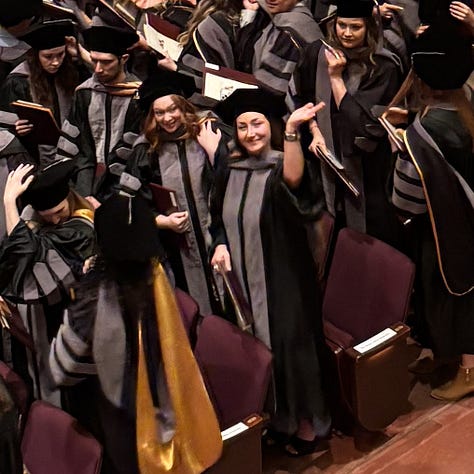 an empty stage set for graduation, 126 veterinary students, a mom and 2 daughters - one who is graduate