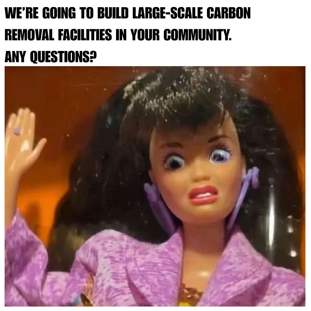 A doll with big dark hair and a lilac jacket raises one hand, wide-eyed and grimacing. Text above reads "We’re going to build large-scale carbon removal facilities in your community. Any questions?"