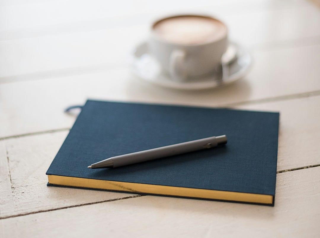 selective focus photography of black pen on book