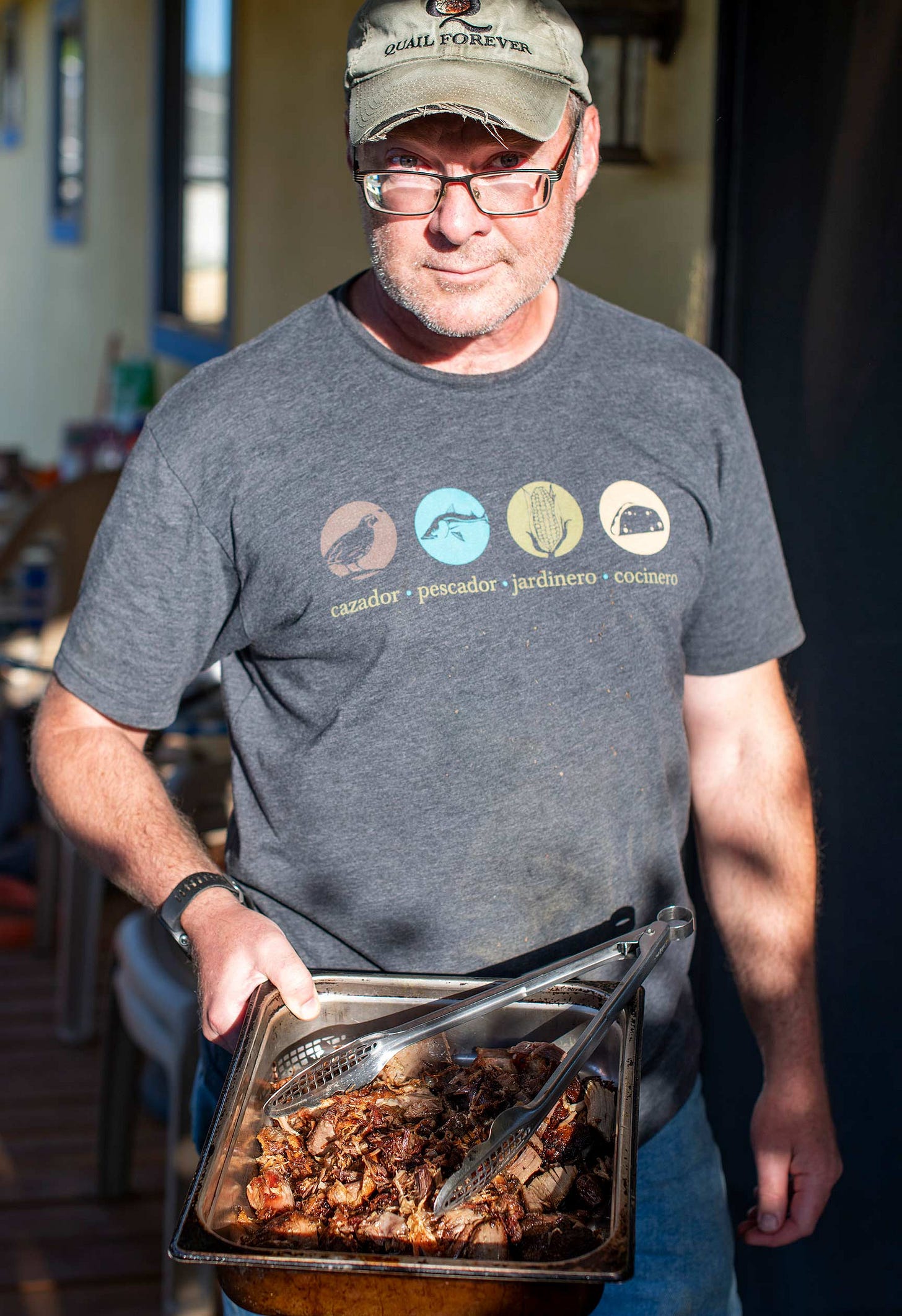 Hank Shaw wearing a Spanish language HAGC logo shirt. 