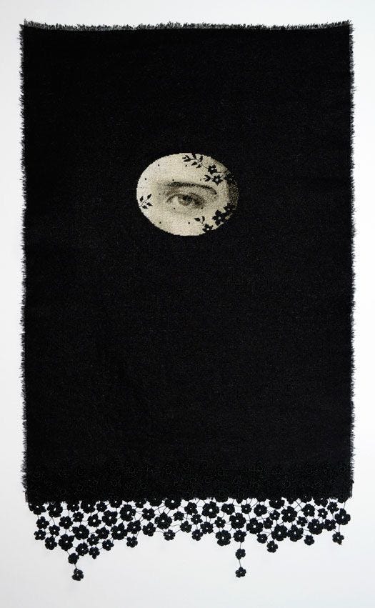 This may contain: a black and white photo with an eye in the center, surrounded by small flowers