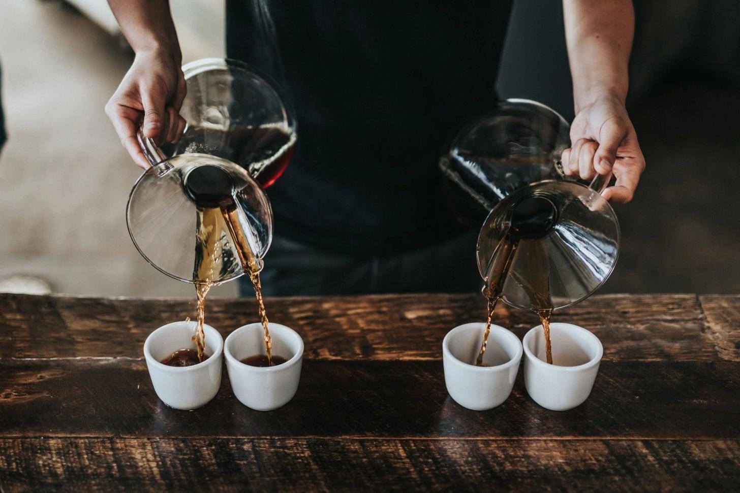 Barista pouring milk into a specialty coffee Barista pouring milk into a specialty coffee