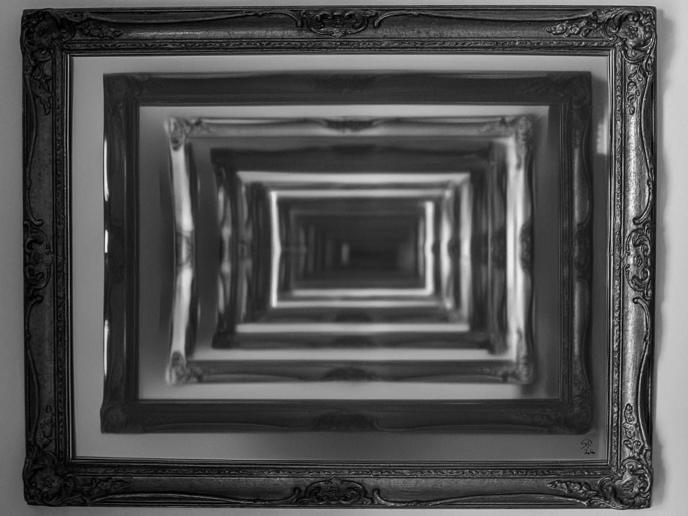 A mirror in an ornate art nouveau frame, endlessly reflecting itself