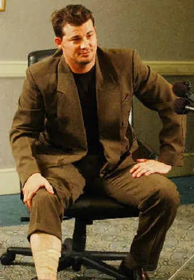 Kyle Denney shows off his bandaged leg at a press conference. Kyle Denney shows off his bandaged leg at a press conference.