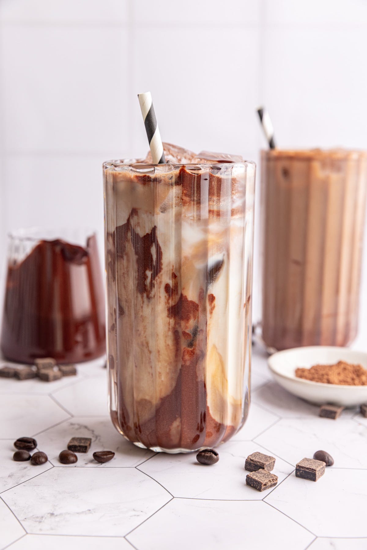 A vegan iced mocha, swirled with chocolate syrup.