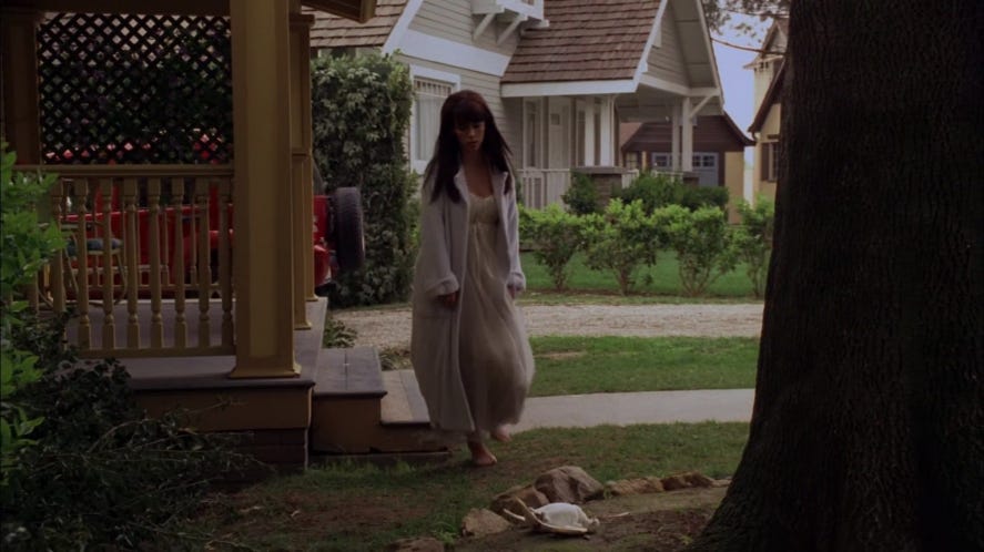 Melinda Gordon steps outside in a robe over a nightgown to retrieve a dead dove from her garden