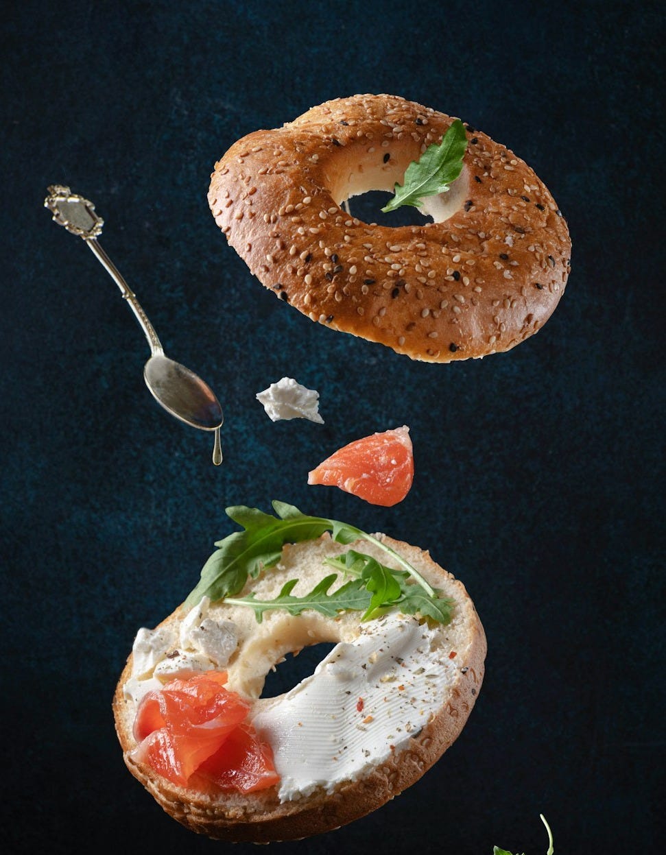 bread with sliced tomato and green vegetable on black textile