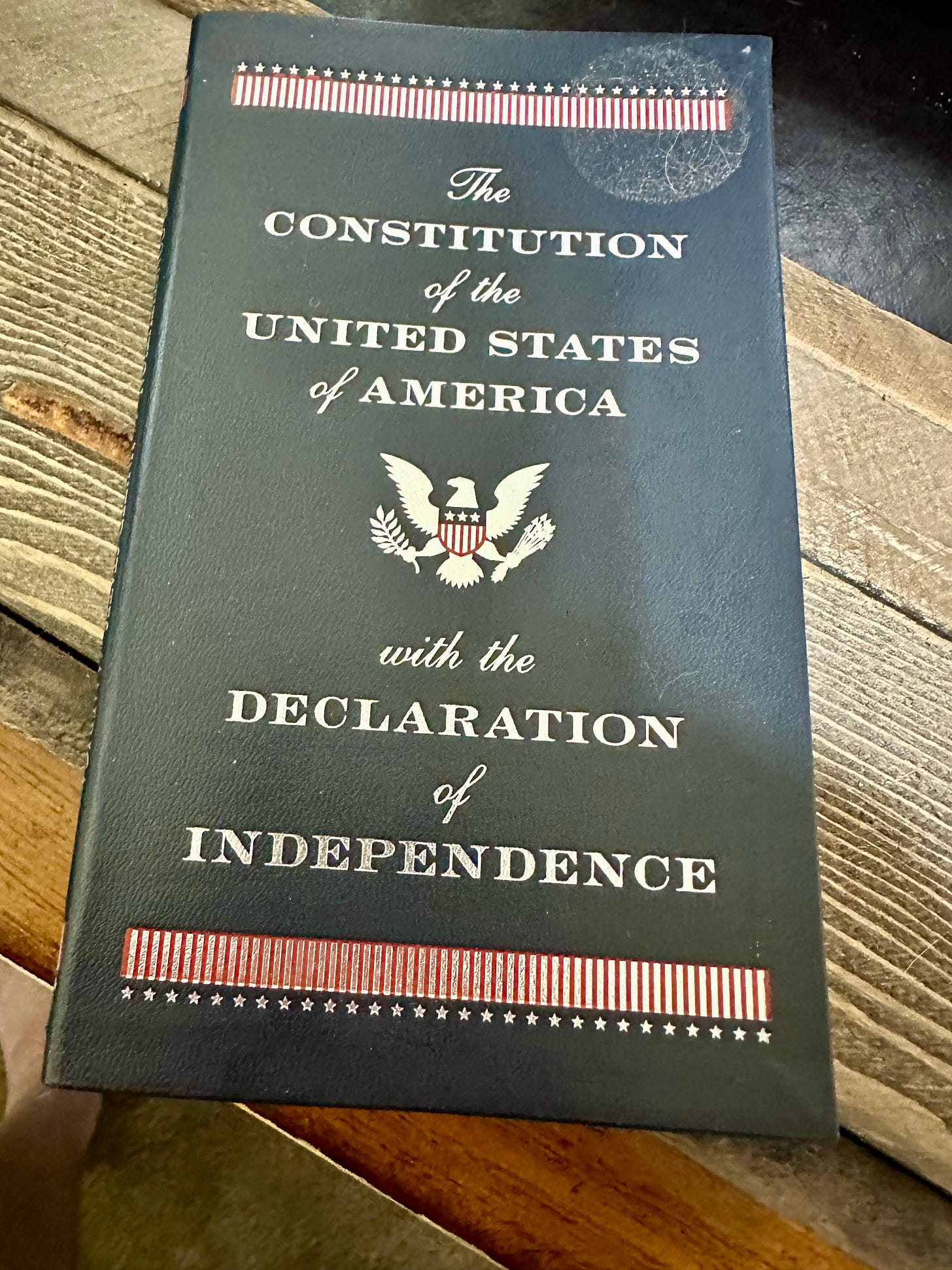 A copy of the US Constitution resting on a wooden box