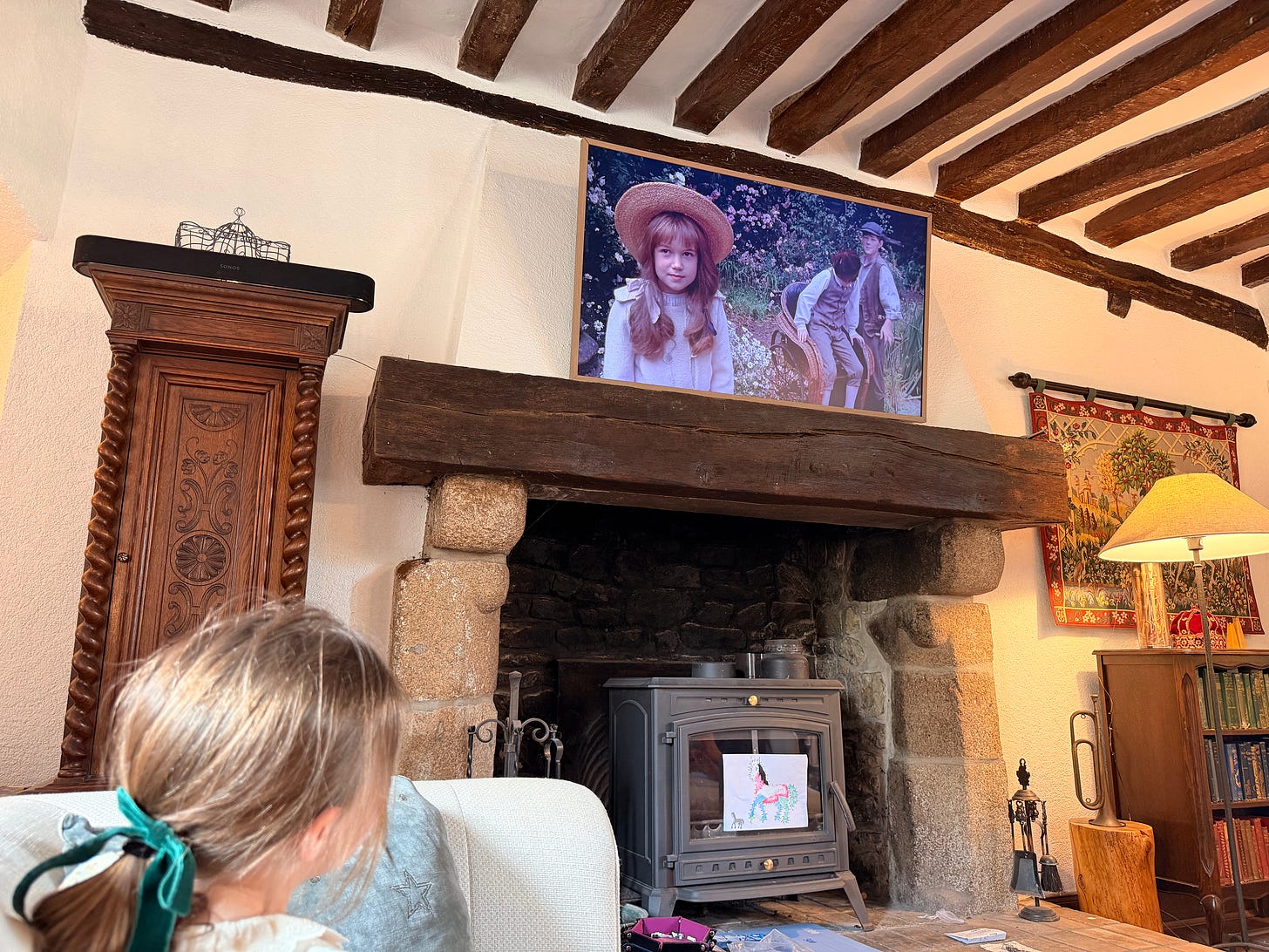 Family relaxing on a sofa watching The Secret Garden movie on Easter afternoon in their French château Family relaxing on a sofa watching The Secret Garden movie on Easter afternoon in their French château