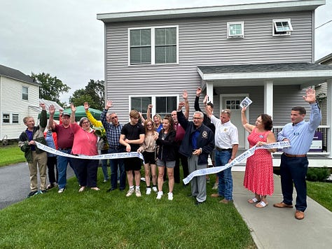 Photos of people at a ribbon cutting, offering gifts to the new homeowners.