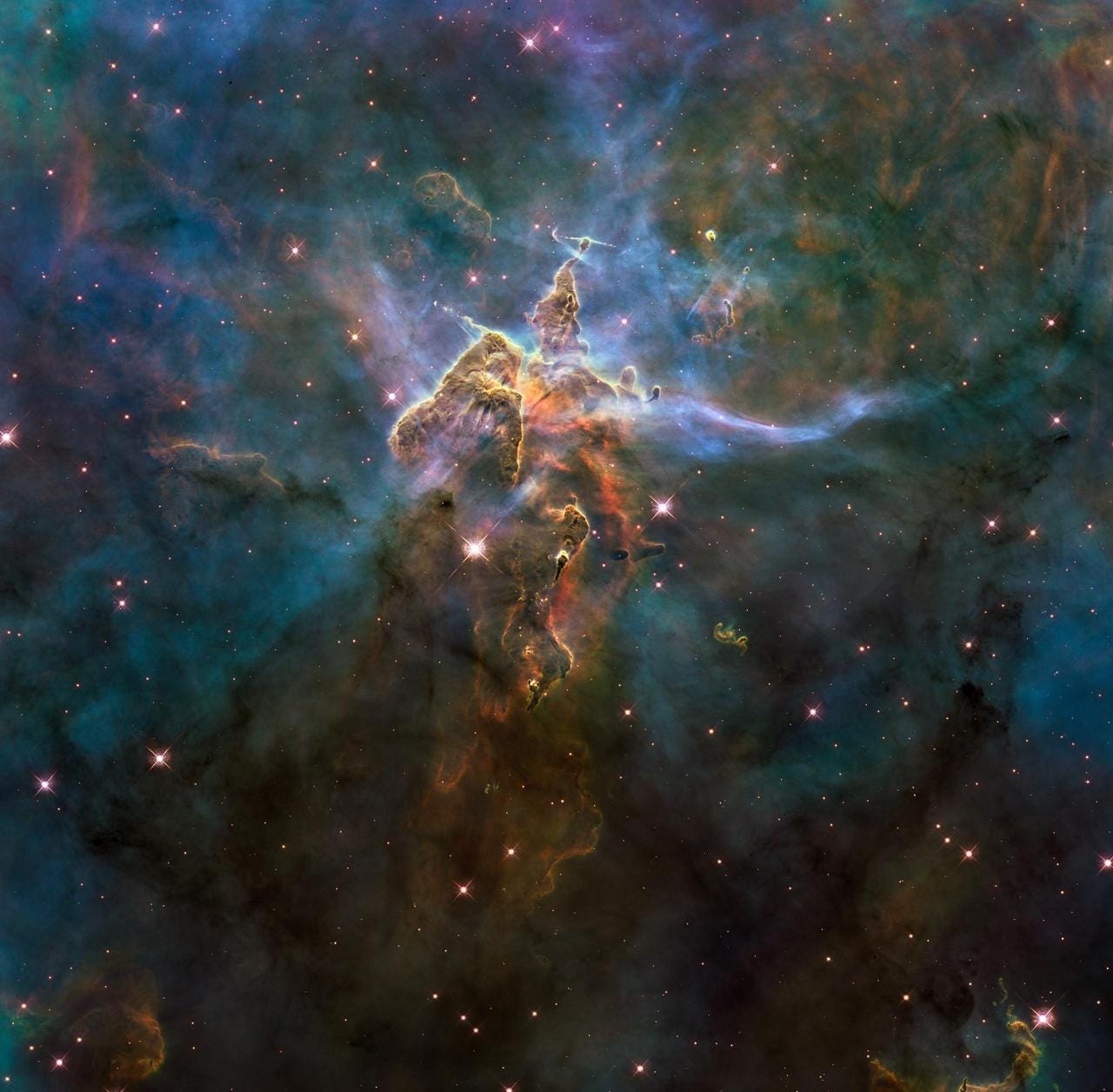 The NASA Hubble Space Telescope photograph, which is stranger than fiction, captures the chaotic activity atop a three-light-year-tall pillar of gas and dust that is being eaten away by the brilliant light from nearby bright stars. The pillar is also being assaulted from within, as infant stars buried inside it fire off jets of gas that can be seen streaming from towering peaks. The NASA Hubble Space Telescope photograph, which is stranger than fiction, captures the chaotic activity atop a three-light-year-tall pillar of gas and dust that is being eaten away by the brilliant light from nearby bright stars. The pillar is also being assaulted from within, as infant stars buried inside it fire off jets of gas that can be seen streaming from towering peaks.