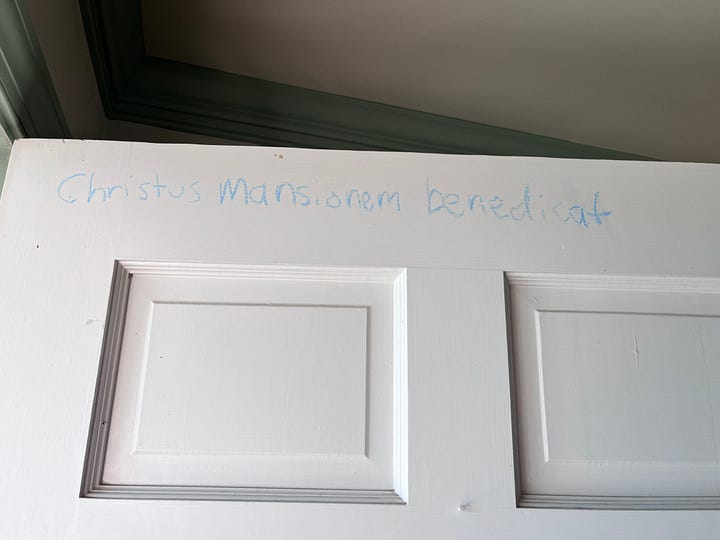 Door chalking on two separate doors in first two pictures (the text will explain more what it is and what it says!) and two photos (slice and whole) of the Twelfth Night Cake I made