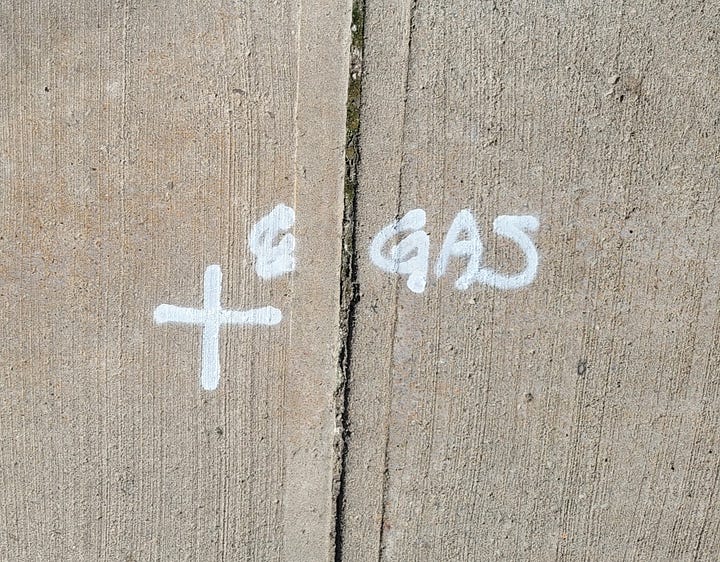 Gas line locations are marked on the sidewalk. 