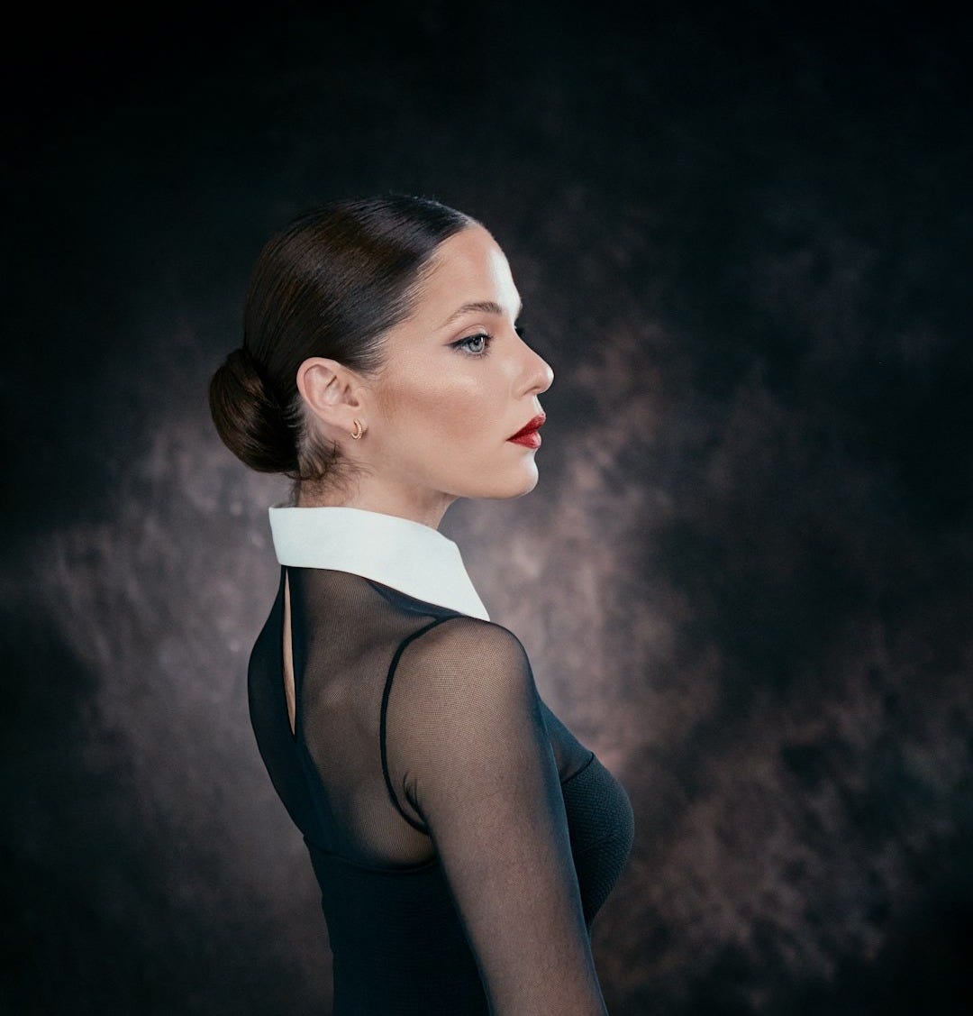 a woman in a black dress with a white collar a woman in a black dress with a white collar