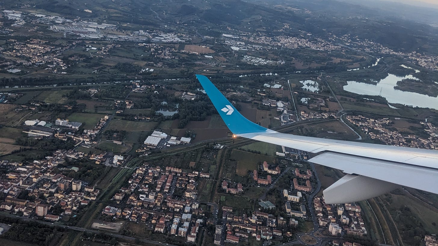 photo taken from the window of a plane of the land below and the plane's wing. photo taken from the window of a plane of the land below and the plane's wing.