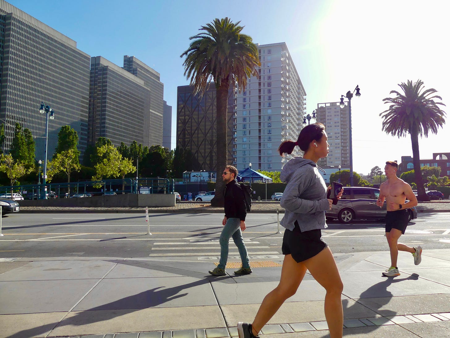 Photograph of walkers and runners along San Francisco's Embarcadero. Photograph of walkers and runners along San Francisco's Embarcadero.