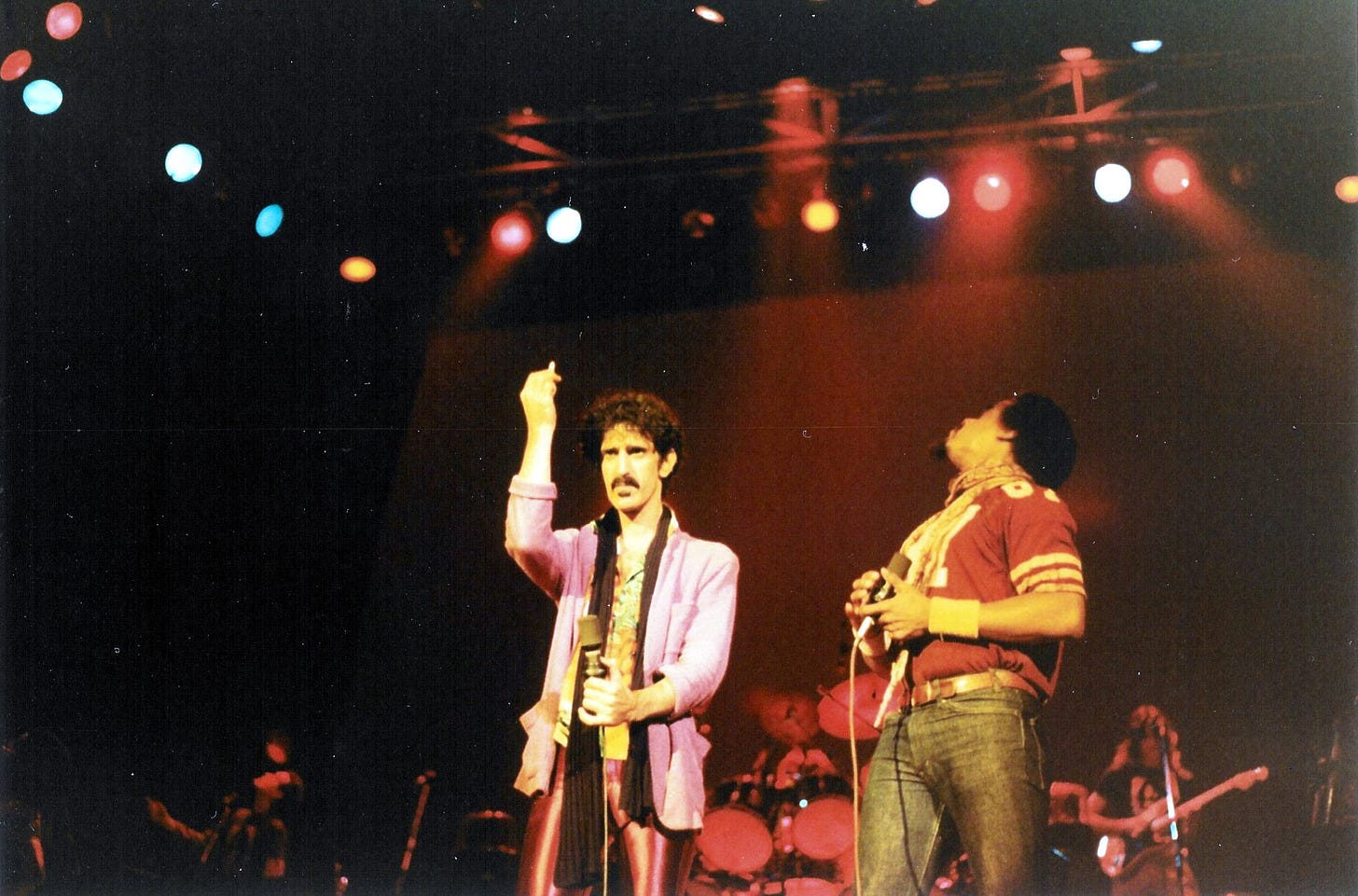 “Frank Zappa and Ike Willis, Memorial Auditorium, Buffalo, NY. Oct 25, 1980” by Eddie Berman, CC-BY-2.0 via Wikimedia Commons.