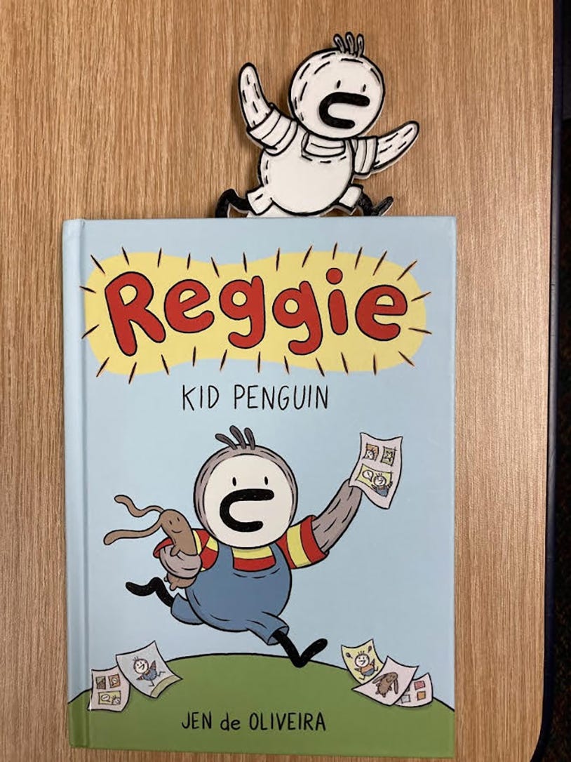 image description:  Reggie Kid Penguin book cover with a 3d printed Reggie bookmark