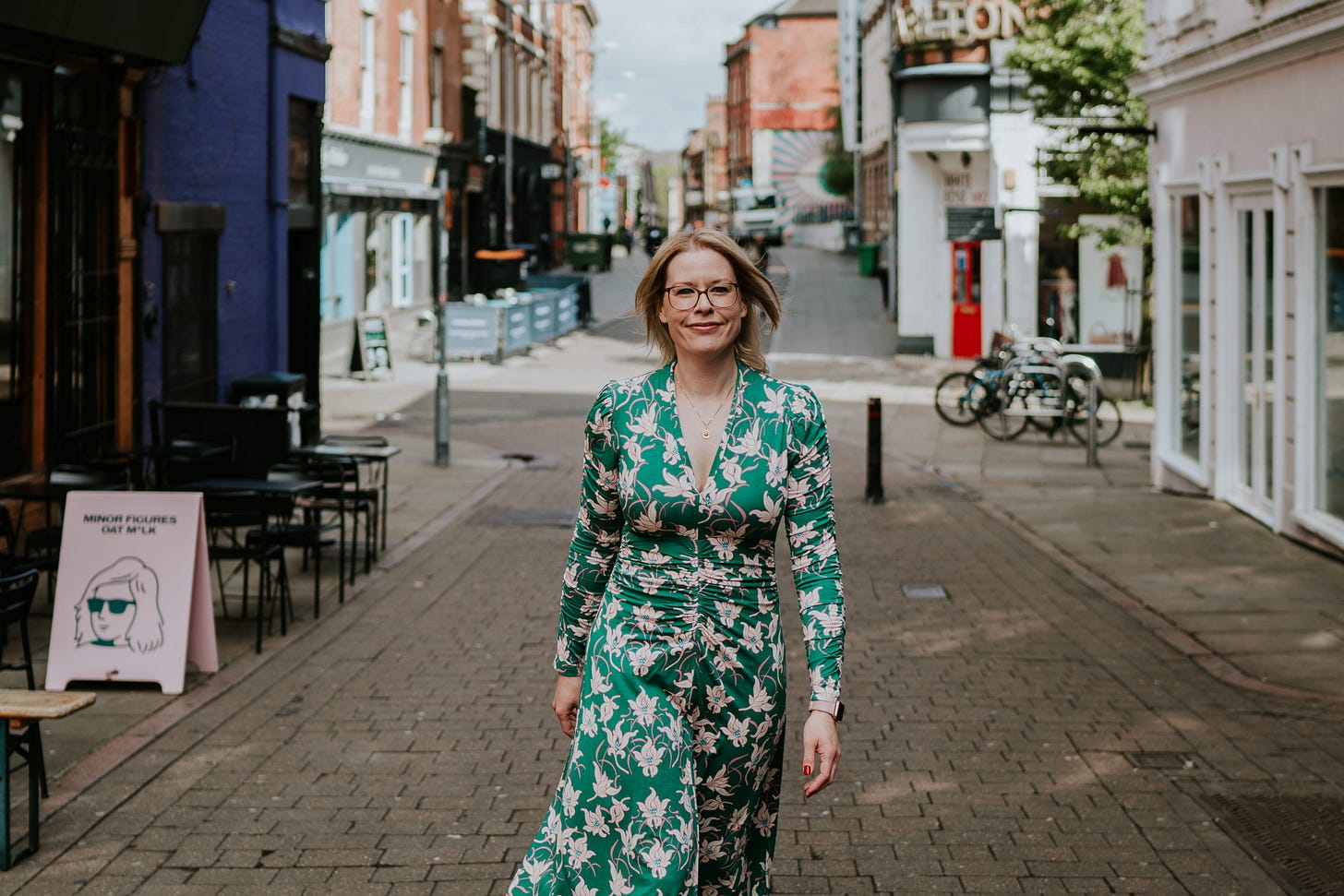 Smiling woman walks down street