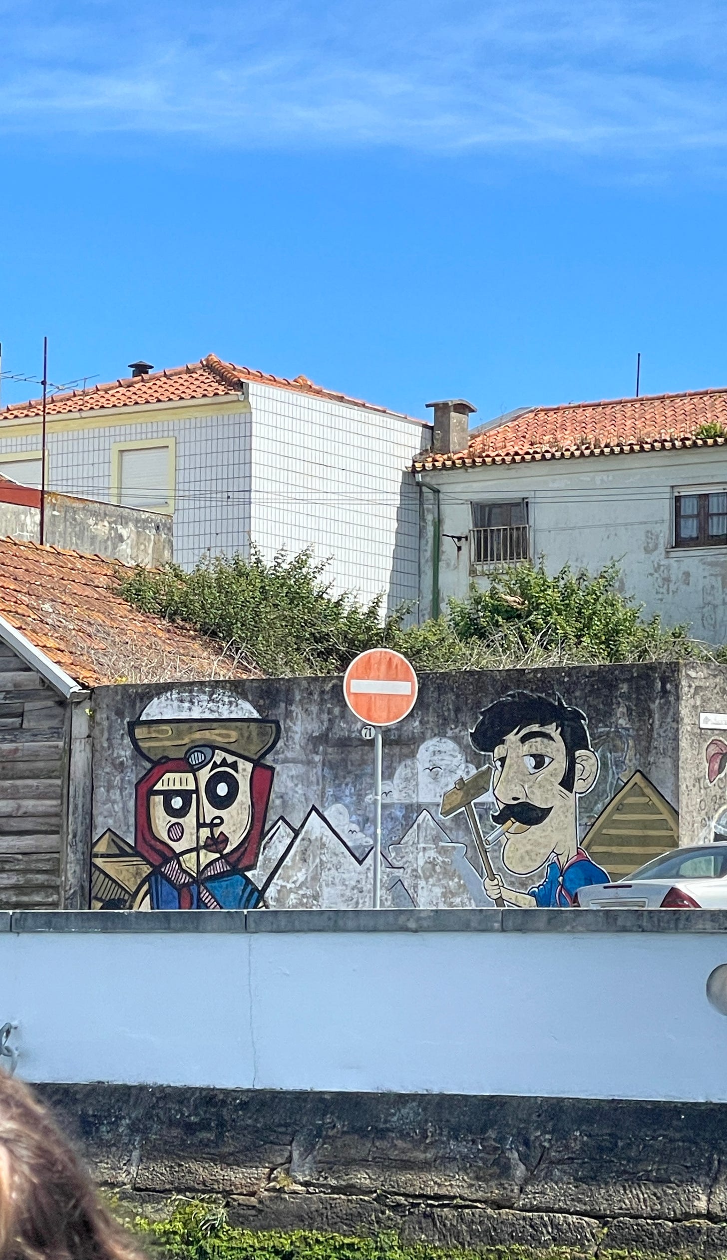 Painting on a wall of a female salt worker with salt being carried on her head and the male worker holding a tool. Piles of salt are painted in the background of the art. Painting on a wall of a female salt worker with salt being carried on her head and the male worker holding a tool. Piles of salt are painted in the background of the art.