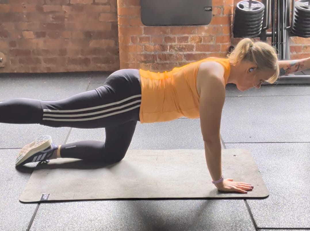 Andrea demonstrating the bird dog exercise